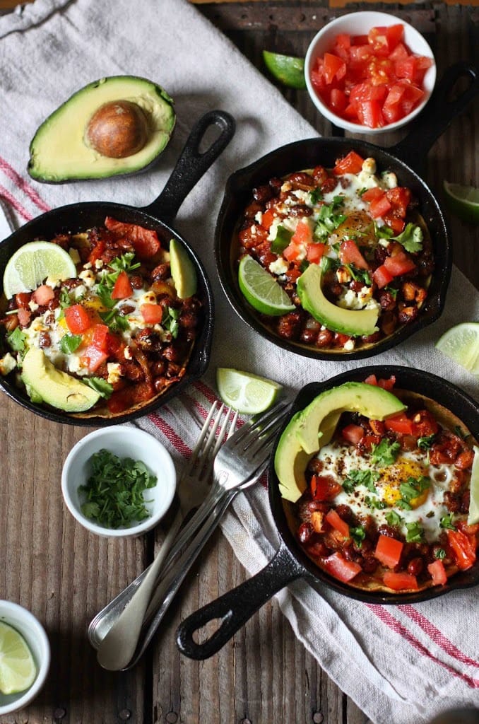 Skillet Huevos Rancheros- with hearty beans, crispy tortilla, avocado and fresh tomato and cilantro...a simple healthy vegetarian brunch recipe! | www.feastingathome.com #huevosrancheros #eggs #brunch #mexicaneggs #mexicanrecipes #recipes