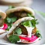 Falafels with Tahini Sauce. This authentic recipe is made with soaked, uncooked chickpeas and hands-down has the BEST texture and flavor! So easy! Bake them or pan-sear them. Great in wraps, bowls, or salads. | #falafel #falafels #falafelrecipe #falafelsalad, #bowl #veganfalafelrecipe #bakedfalafel #vegan #easyfalafel