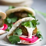 Falafels with Tahini Sauce. This authentic recipe is made with soaked, uncooked chickpeas and hands-down has the BEST texture and flavor! So easy! Bake them or pan-sear them. Great in wraps, bowls, or salads. |  #falafel #falafels #falafelrecipe #falafelsalad, #bowl #veganfalafelrecipe #bakedfalafel #vegan #easyfalafel