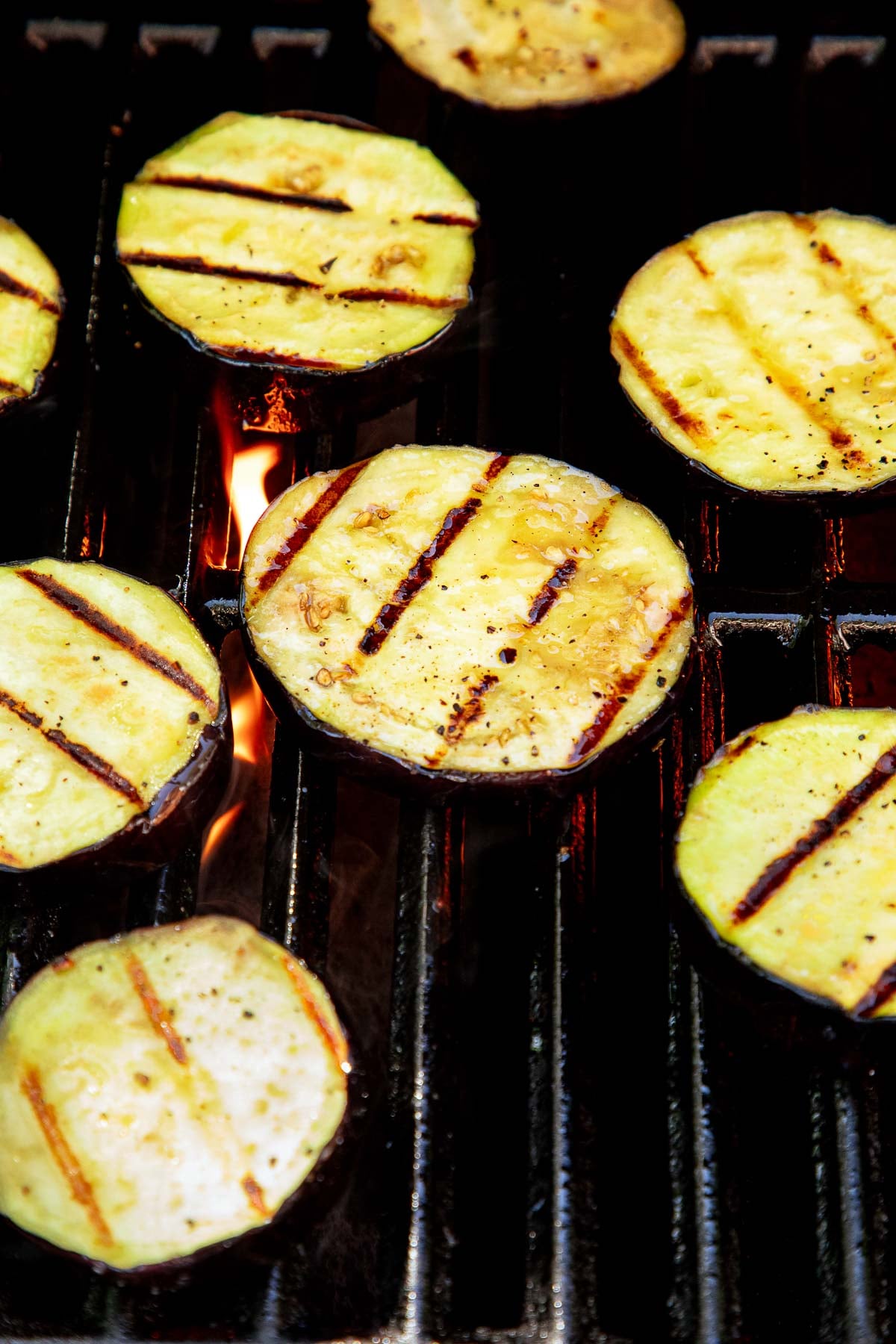slices of grilled eggplant on the grill.