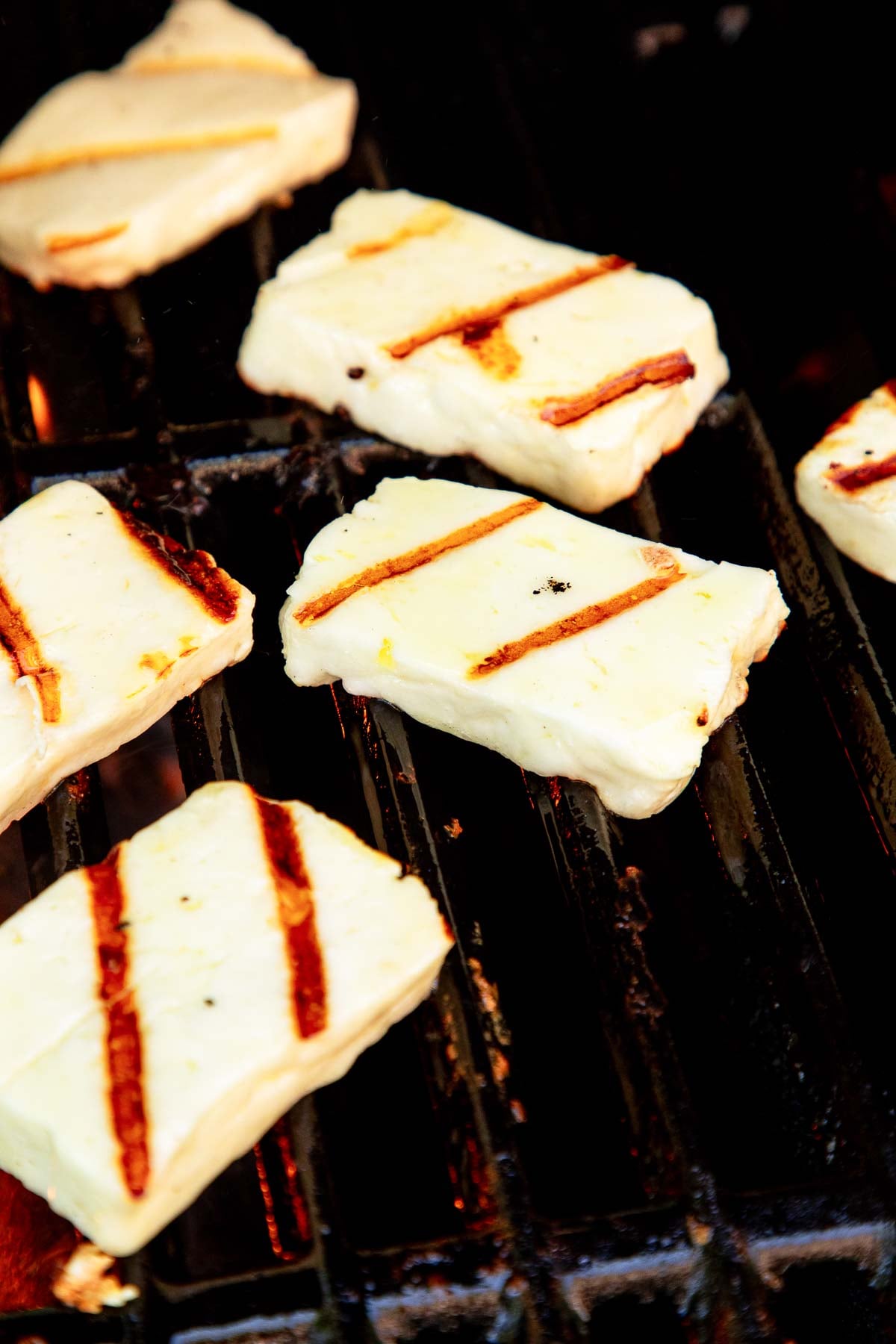 slices of grilled halloumi cheese on the grill.