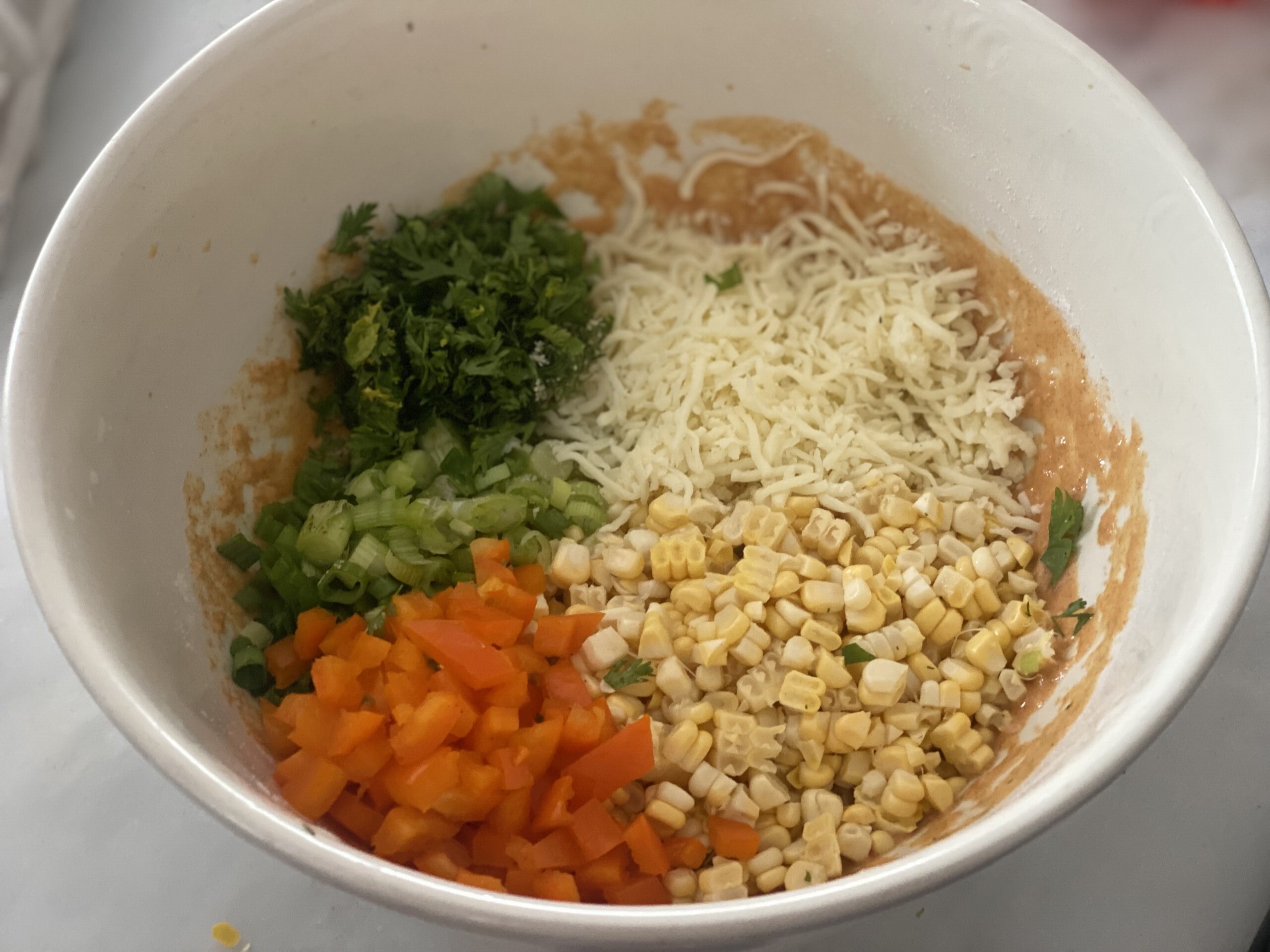 folding in the corn, cheese, scallions, cilantro and bell pepper. 