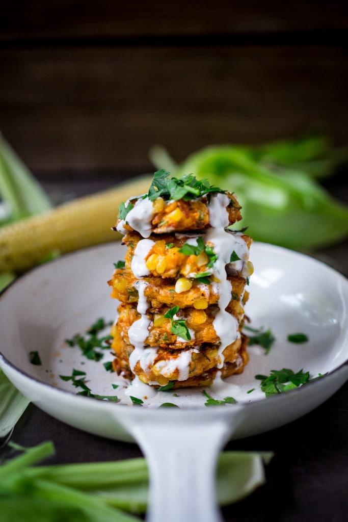 Corn Fritters with Cilantro Cream - an easy delicious recipe that works as an appetizer or vegetarian main! www.feastingathome.com #cornfritters #corncakes 