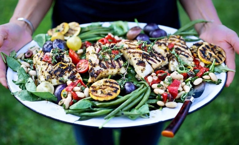 Grilled Summer Nicoise Salad w/ fresh grilled fish, baby potatoes, olives, roasted peppers, french beans & lemony mustard seed vinaigrette. Gluten free and Healthy! |www.feastingathome.com