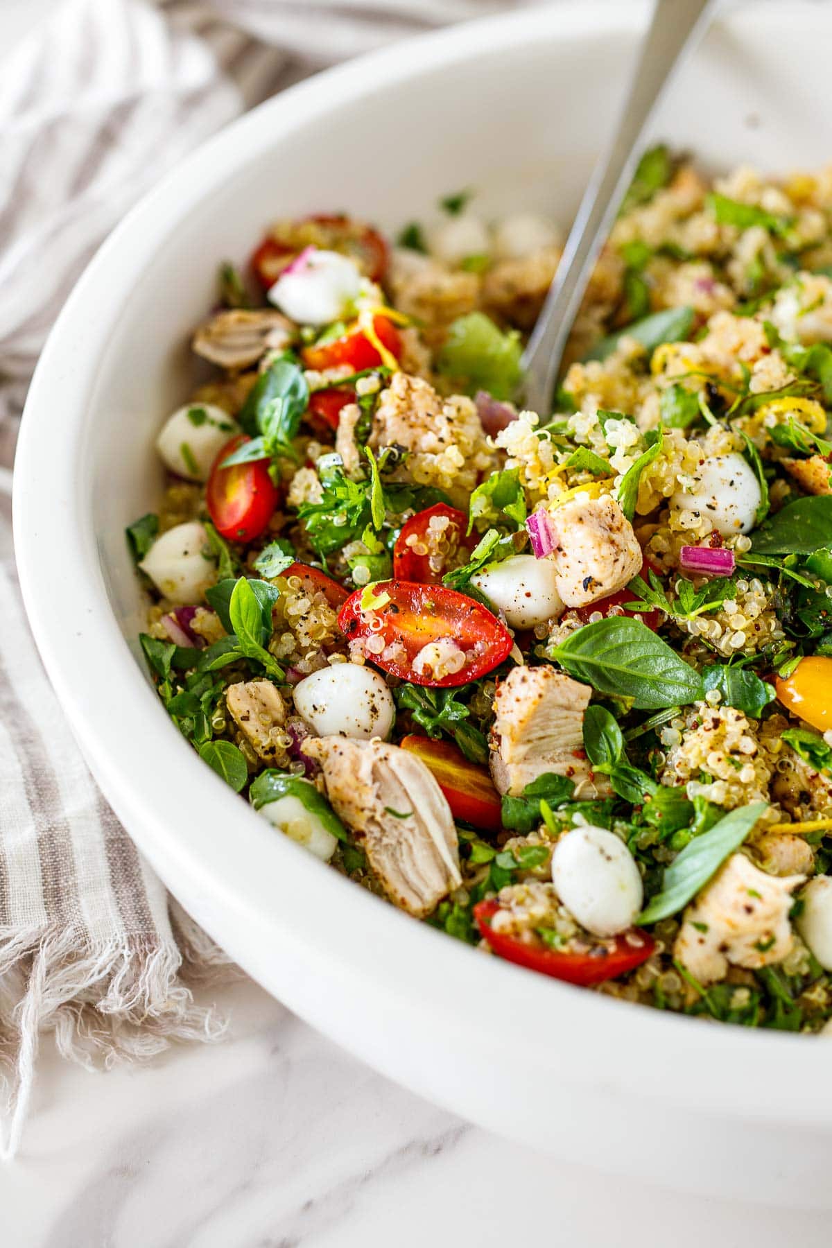 Close up shot of the quinoa salad with a spoon.