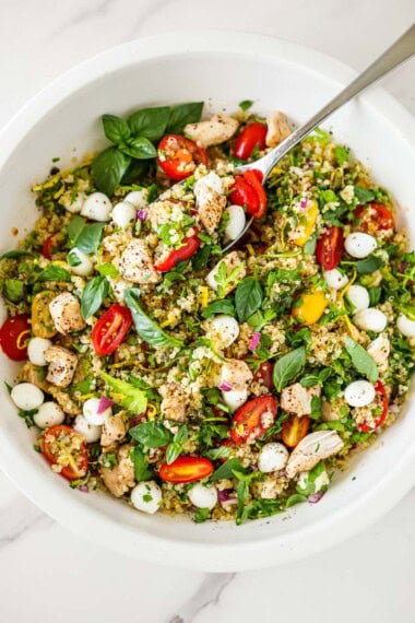 This protein-packed Chicken Quinoa Salad is loaded with fresh herbs, cherry tomatoes, and mozzarella, all tossed in a zesty lemon vinaigrette. Perfect for meal prep, summer lunches, or light dinners!