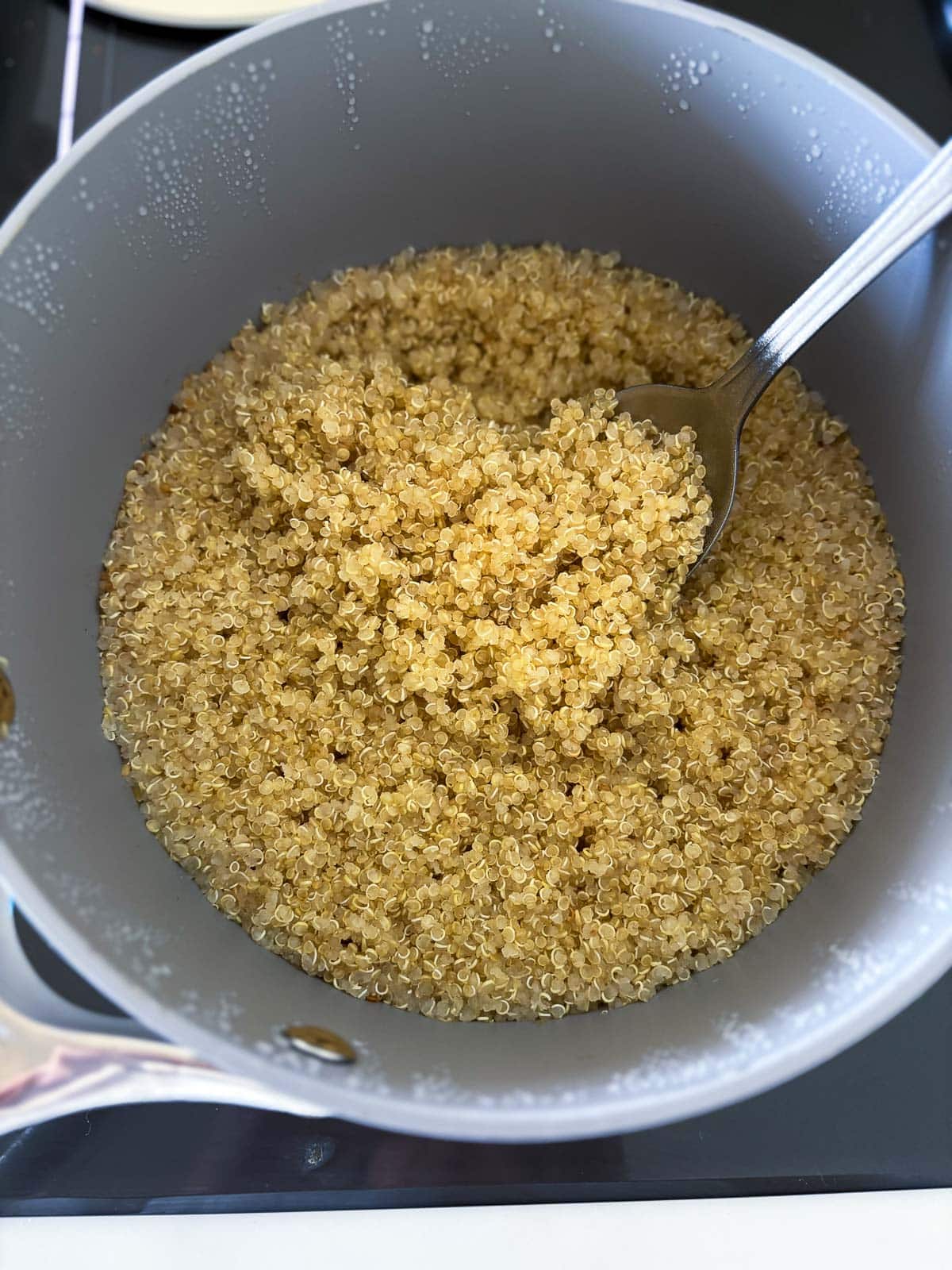 Cooking the quinoa in a medium pot.