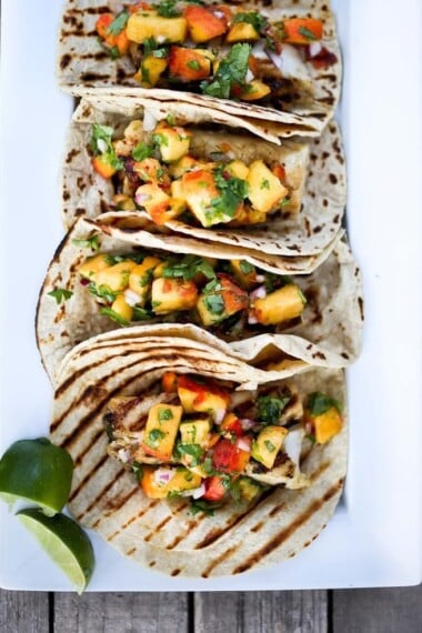 Chipotle Fish Tacos with Peach Salsa | www.feastingathome.com