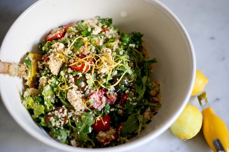 tossing the chicken quinoa salad.