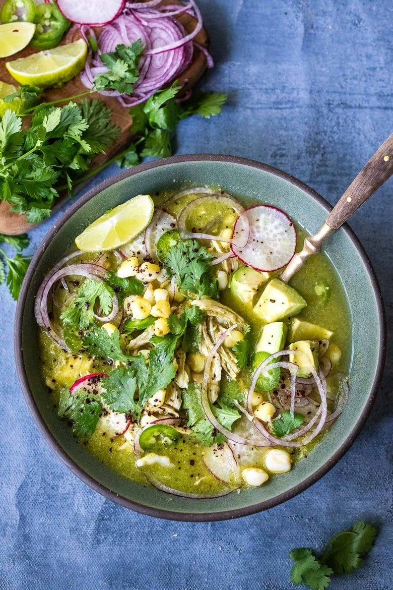 A bowl of Pozole Verde ( Green Pozole) with a spoon.