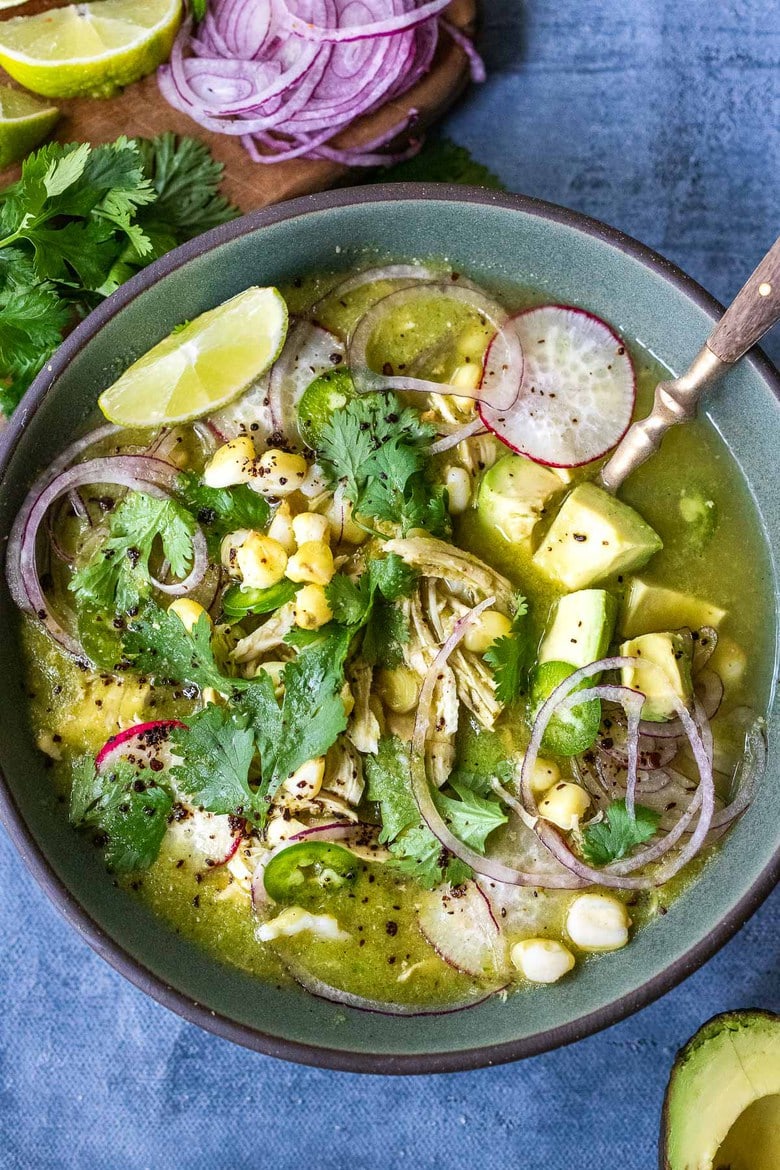 35 Fresh and TAsty Mexican Recipes! | Pozole Verde- a flavorful Mexican stew made with tomatillos, green chilies, chicken and hominy, topped with cilantro, avocado and red onions. #pozole