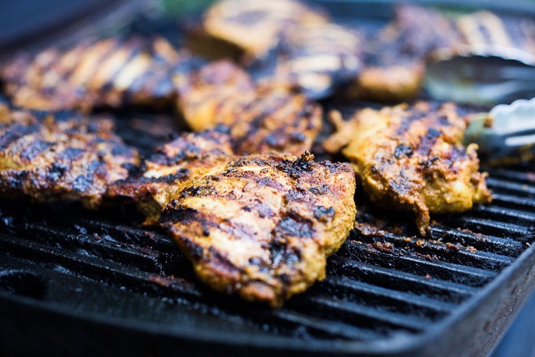 Grilled Tandoori Chicken- an easy authentic Indian recipe with a simple yogurt marinade using chicken thighs. Served with naan and Raita Sauce. #tandoorichicken #grilled #grilledchicken #indianrecipe 