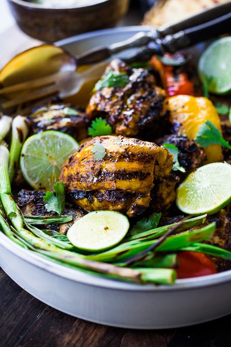 Grilled Tandoori Chicken- an easy authentic Indian recipe with a simple yogurt marinade using chicken thighs. Served with naan and Raita Sauce. #tandoorichicken #grilled #grilledchicken #indianrecipe