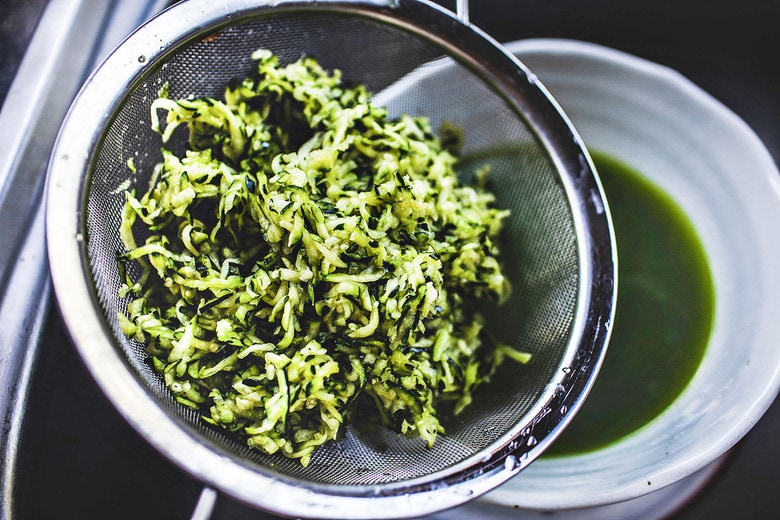 Zucchini Fritters with dill, feta and Tzatziki Sauce, a simple easy way to use up summer squash and zucchini! Healthy and light! #zucchinifritters #zucchinicakes #zucchinirecipes