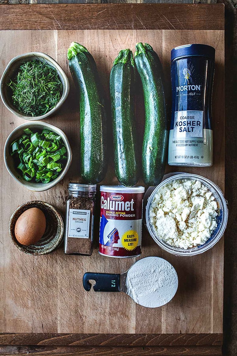 Ingredients in Zucchini Fritters with dill, feta and Tzatziki Sauce, a simple easy way to use up summer squash and zucchini! Healthy and light! #zucchinifritters #zucchinicakes #zucchinirecipes