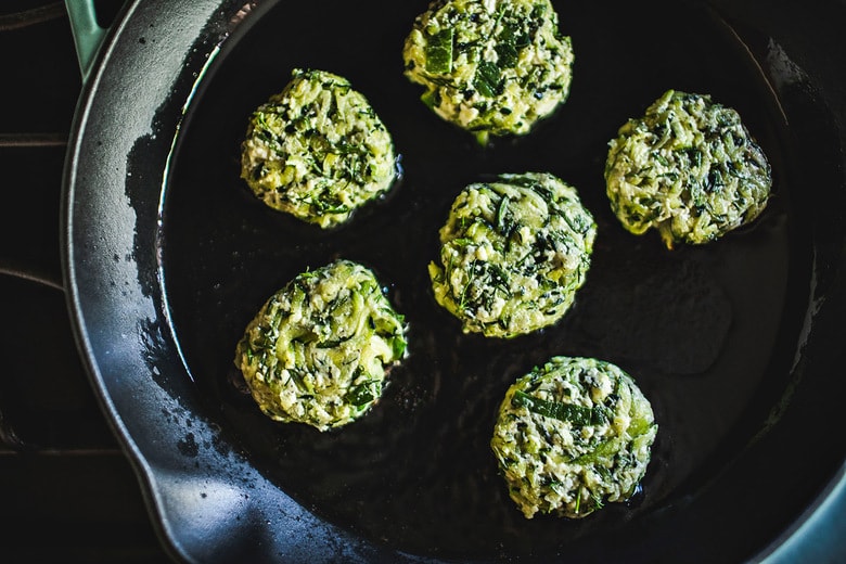 Zucchini Fritters with dill, feta and Tzatziki Sauce, a simple easy way to use up summer squash and zucchini! Healthy and light! #zucchinifritters #zucchinicakes #zucchinirecipes