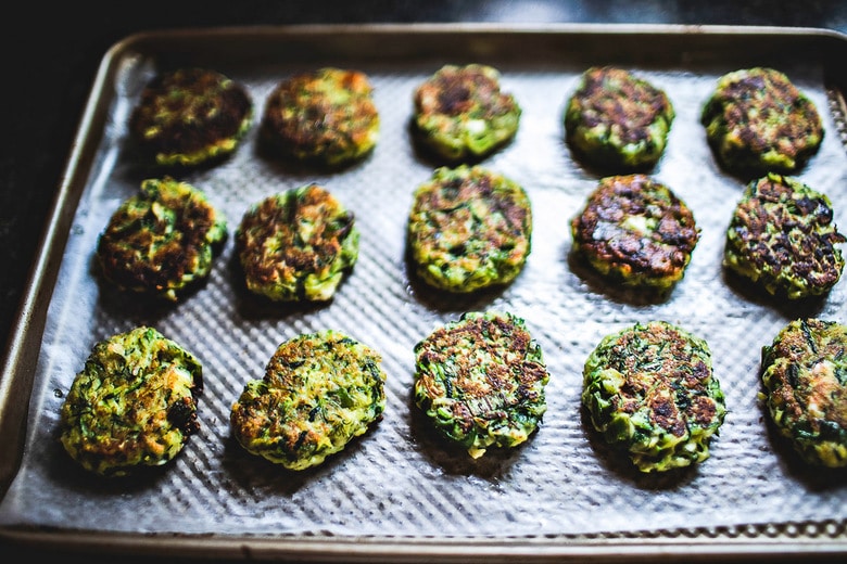 Zucchini Fritters with dill, feta and Tzatziki Sauce, a simple easy way to use up summer squash and zucchini! Healthy and light! #zucchinifritters #zucchinicakes #zucchinirecipes