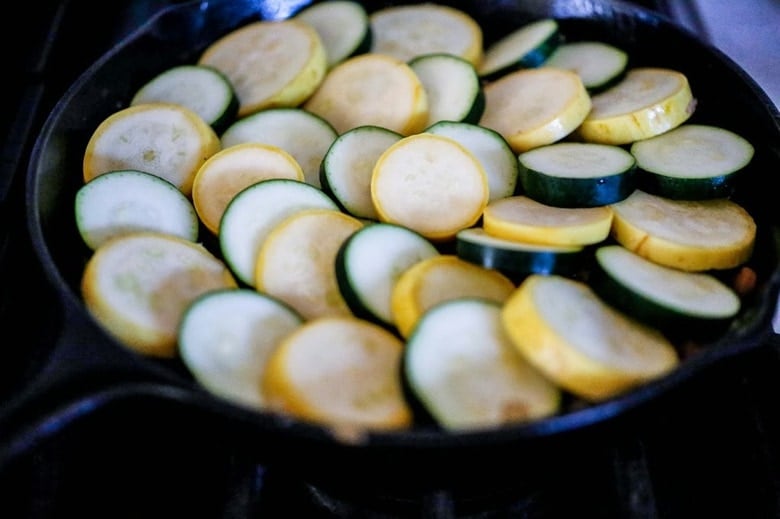 Baked Zucchini Tian with Middle Eastern Spices served over rice for simple vegetarian meal, or as a delicious side dish. Healthy and Vegan! #bakedzucchini #vegan #zucchini #zucchinitian #zucchinirecipes 