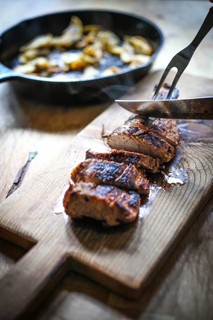 Grilled Pork with Hard Cider Pan Sauce, sautéed apples and sage. A delicious meal, perfect for fall. | www.feastingathome.com