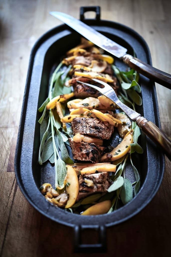 Grilled Pork with Hard Cider Pan Sauce, sautéed apples and sage. A delicious meal, perfect for fall. | www.feastingathome.com