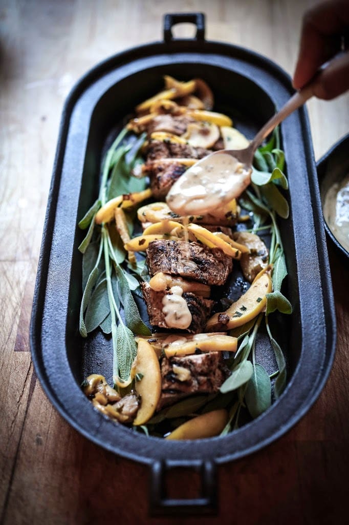 Grilled Pork with Hard Cider Pan Sauce, sautéed apples and sage. A delicious meal, perfect for fall. | www.feastingathome.com