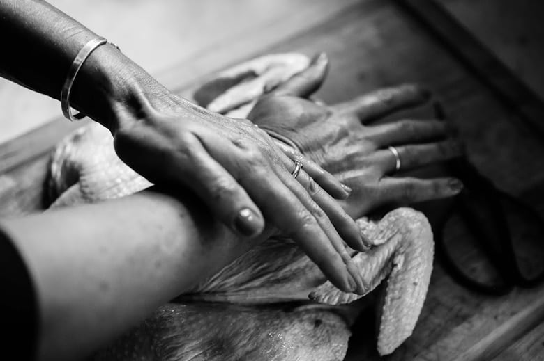 Pressing down hard on the Breast bone,  to flatten. 