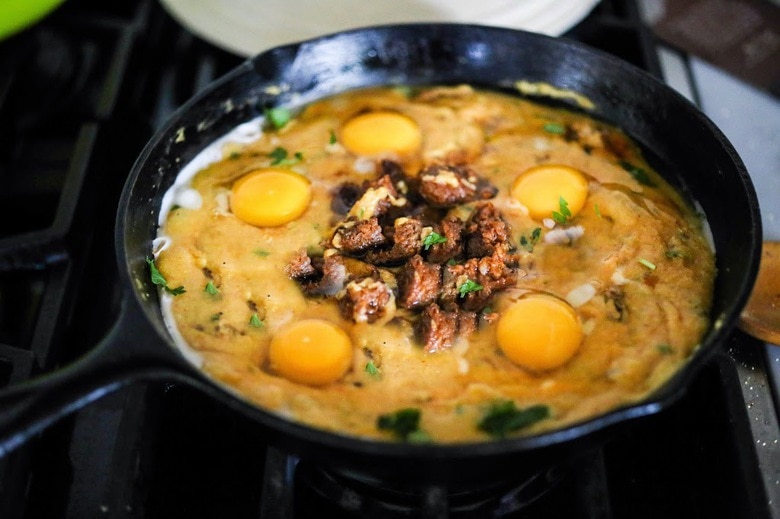 Creamy Polenta with poached eggs, spicy chorizo and cilantro- a delicious hearty brunch that is full of flavor! Feel free to use vegan chorizo or turkey chorizo!