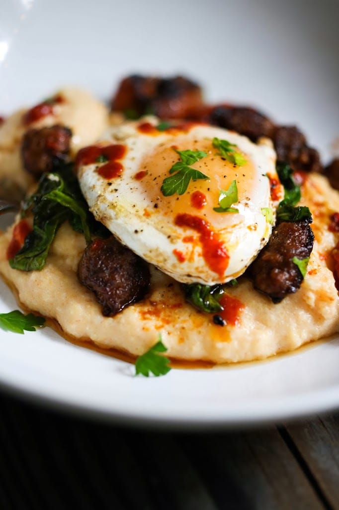 Creamy Polenta with poached eggs, chorizo and cilantro- a flavorful hearty brunch! #polenta #eggs #chorizo #brunch #breakfast #brunchrecipes #polentaeggs 