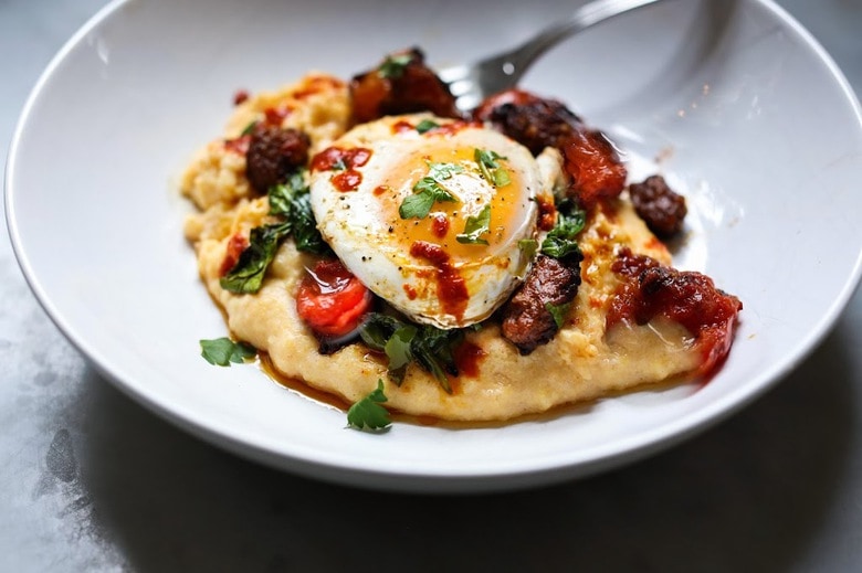 Creamy Polenta with poached eggs, chorizo and cilantro- a flavorful hearty brunch! #polenta #eggs #chorizo #brunch #breakfast #brunchrecipes #polentaeggs