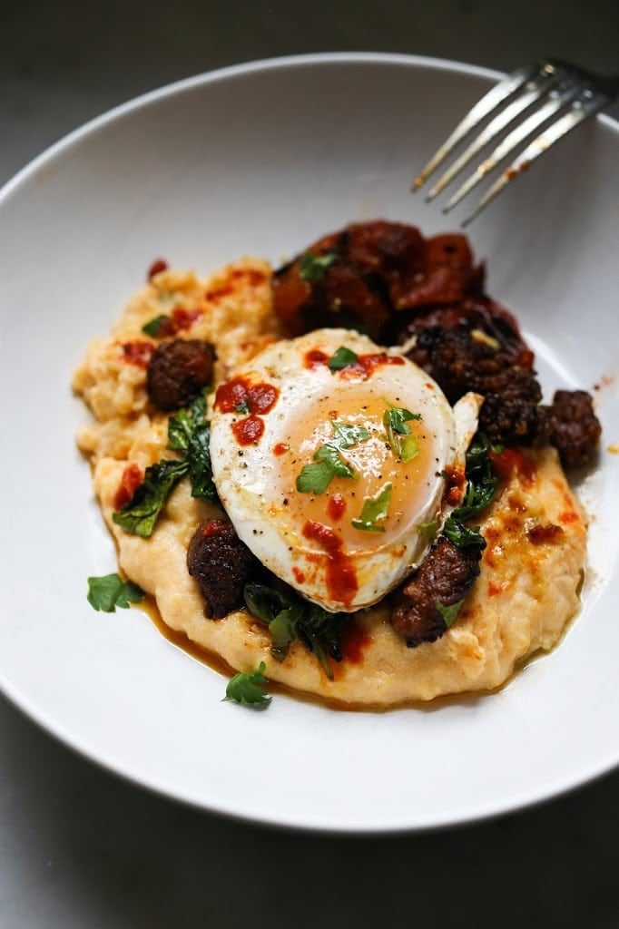 Creamy Polenta with poached eggs, chorizo and cilantro- a flavorful hearty brunch! #polenta #eggs #chorizo #brunch #breakfast #brunchrecipes #polentaeggs 