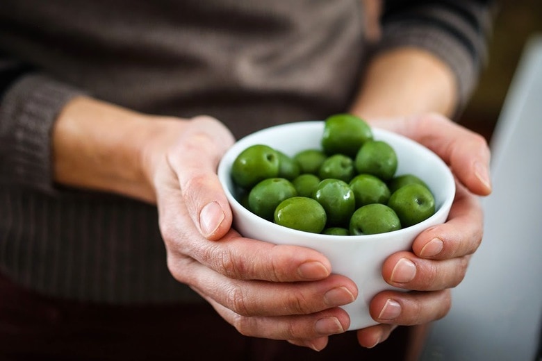 Warm olives with rosemary, garlic, and almonds - a simple, delicious appetizer that is full of amazing flavor, that can be made very quickly and easily! #warmolives #olives #marcona #almonds #rosemaryolives