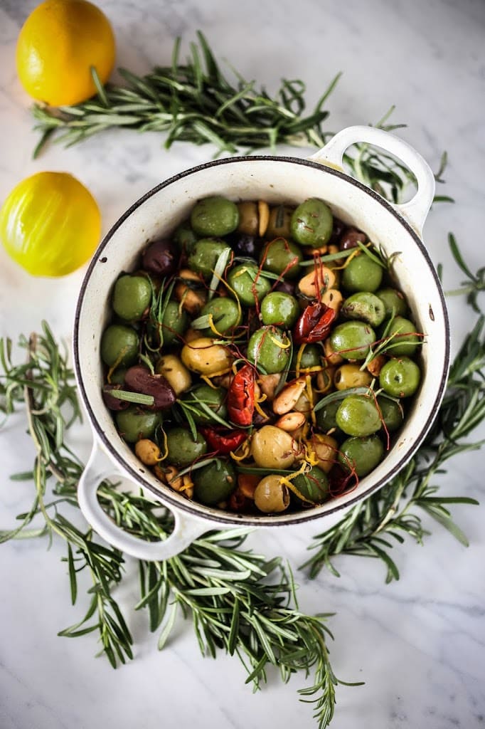 35+ Best Potluck Ideas| Warm Olives with rosemary, garlic, marcona almonds, fennel seeds and chili threads.