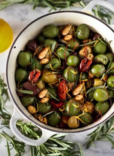 Warm olives with rosemary, garlic, and almonds - a simple, delicious appetizer that is full of amazing flavor, that can be made very quickly and easily! #warmolives #olives #marcona #almonds #rosemaryolives