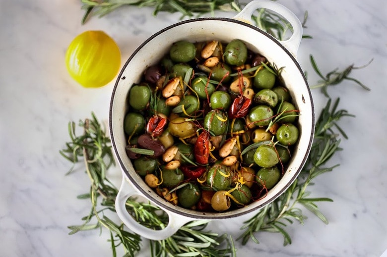 Warm olives with rosemary, garlic, and almonds - a simple, delicious appetizer that is full of amazing flavor, that can be made very quickly and easily! #warmolives #olives #marcona #almonds #rosemaryolives