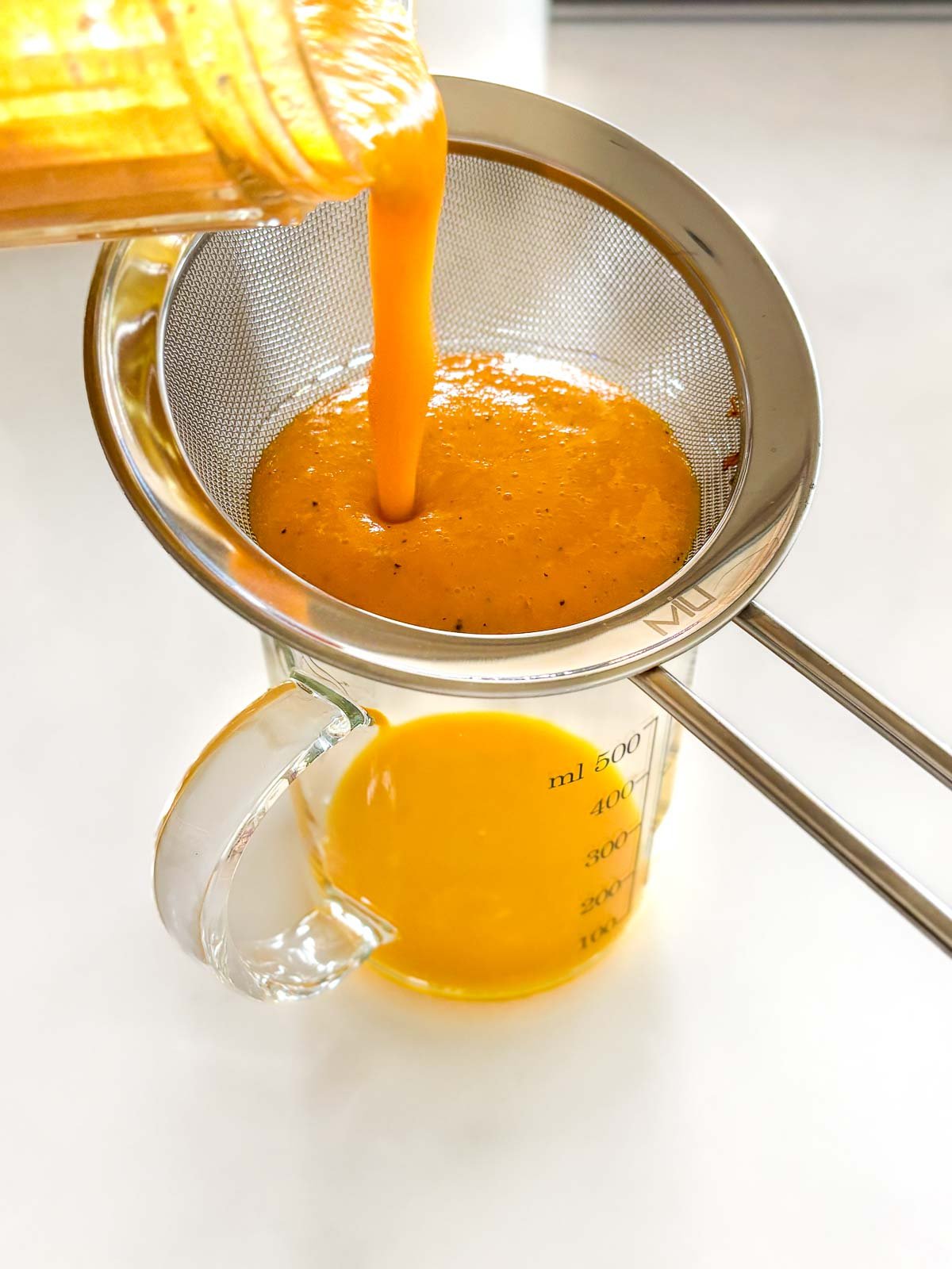 straining the immunity shots through a fine mesh strainer.