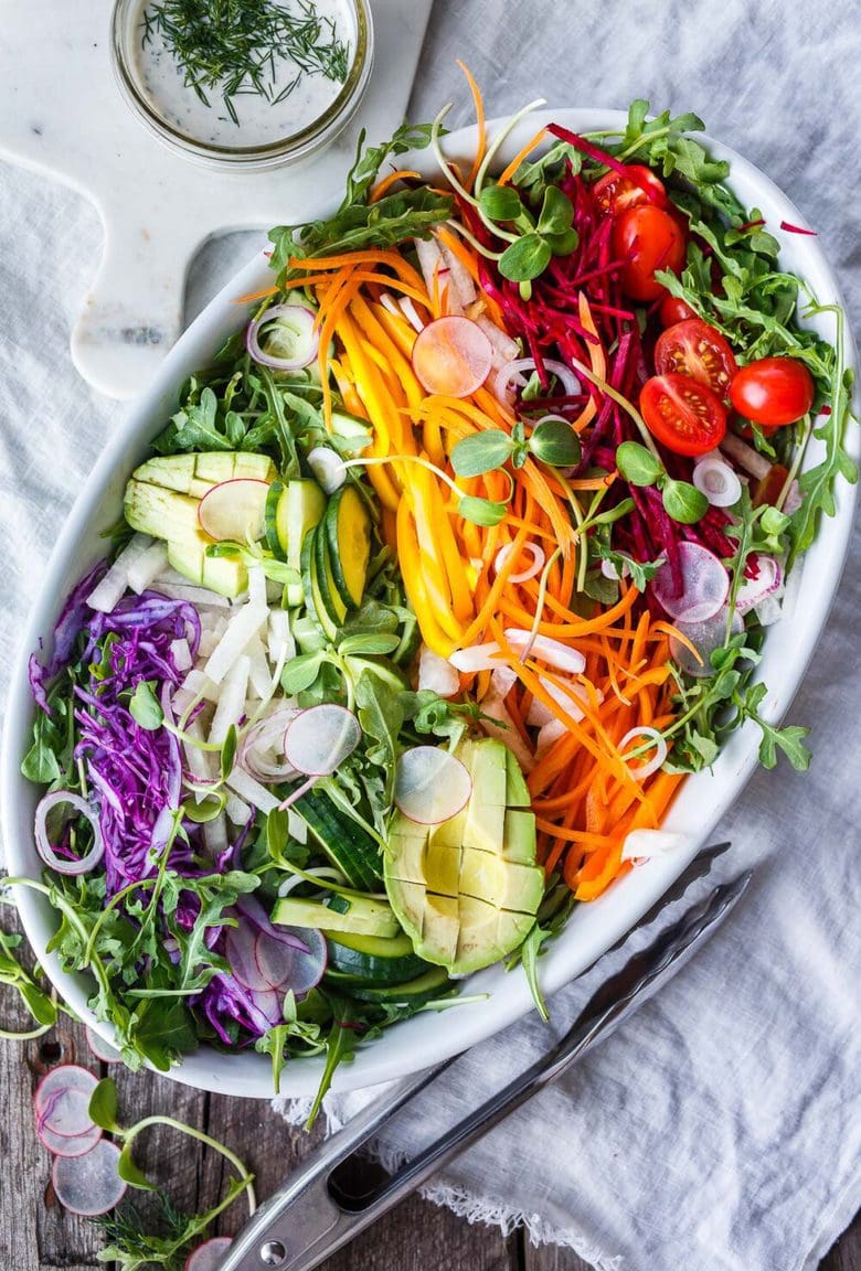 This beautiful Rainbow Salad is full of healthy seasonal veggies and can be made ahead and brought to potlucks and gatherings. Vegan adaptable!  Serve it with Herby hemp Dressing or Dilly Ranch Dressing. Vegan Adaptable!
