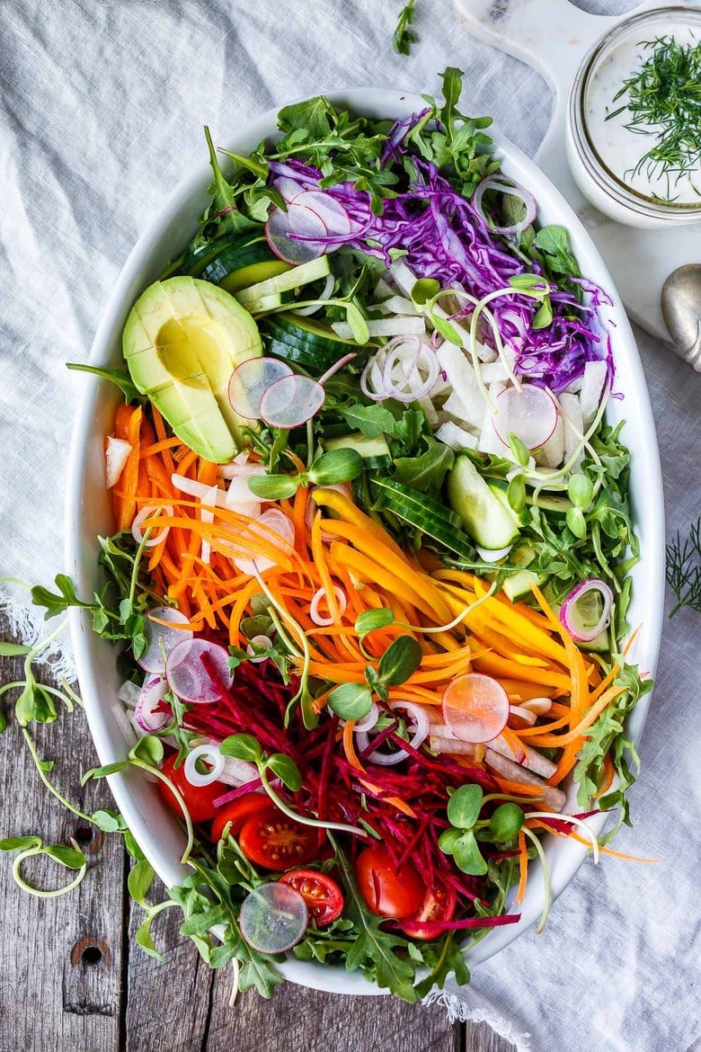 This beautiful Rainbow Salad is full of healthy seasonal veggies and can be made ahead and brought to potlucks and gatherings. Vegan adaptable! Serve it with Herby hemp Dressing or Dilly Ranch Dressing. Vegan Adaptable!