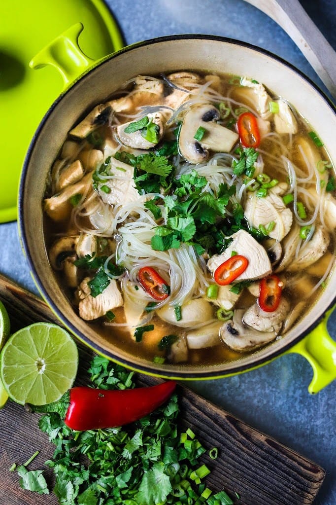 A steaming bowl of Thai Chicken Noodle Soup infused with lemongrass and ginger.  A healthy, low fat, gluten-free meal, full of amazing Thai flavors! #thaisoup #chickensoup #thainoodlesoup #lemongrass #broth #brothysoup