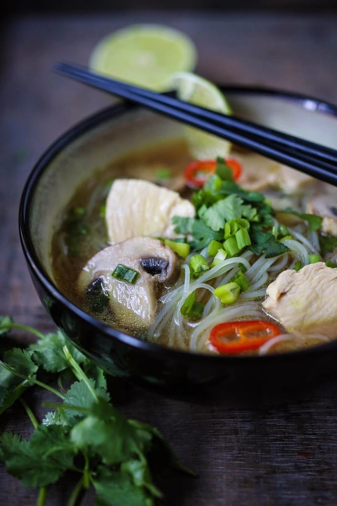 A steaming bowl of Thai Chicken Noodle Soup infused with lemongrass and ginger.  A healthy, low fat, gluten-free meal, full of amazing Thai flavors!