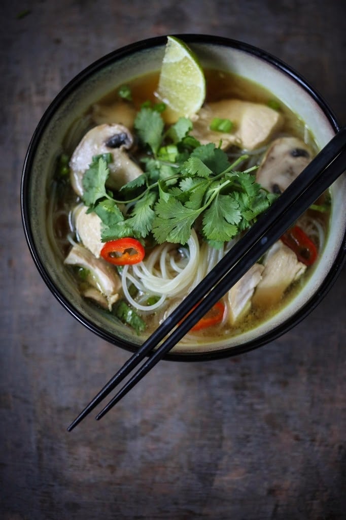 A steaming bowl of Thai Chicken Noodle Soup infused with lemongrass and ginger.  A healthy, low fat, gluten-free meal, full of amazing Thai flavors! #thaisoup #chickensoup #thainoodlesoup #lemongrass #broth #brothysoup