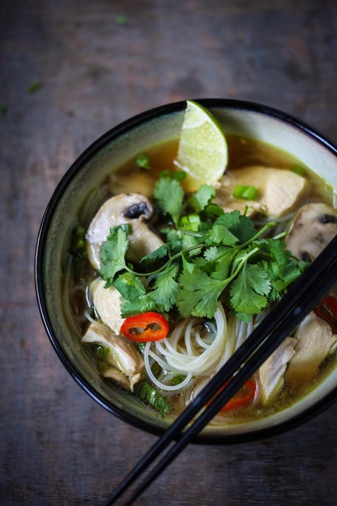 A steaming bowl of Thai Chicken Noodle Soup infused with lemongrass and ginger.  A healthy, low fat, gluten-free meal, full of amazing Thai flavors!