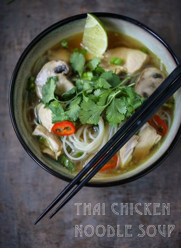 A steaming bowl of Thai Chicken Noodle Soup infused with lemongrass and ginger.  A healthy, low fat, gluten-free meal, full of amazing Thai flavors! #thaisoup #chickensoup #thainoodlesoup #lemongrass #broth #brothysoup