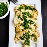 This Roasted Cauliflower Steak Recipe is topped with an herby zesty green sauce called Gremolata. A delicious vegan dinner idea!