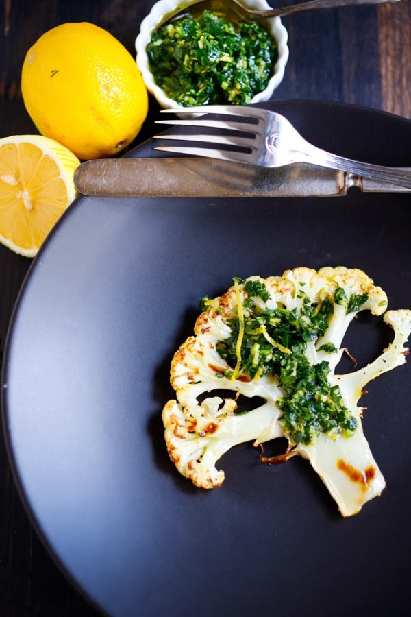 Roasted Cauliflower Steaks with Gremolata, a healthy delicious vegan side dish you that is simple and easy, and full of flavor! www.feastingathome.com #cauliflower #veganside #vegan #sidedish #healthy #cauliflowersteaks
