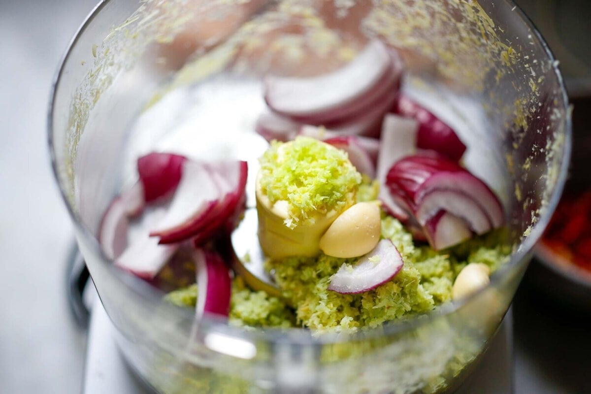 food processor with lemongrass, garlic, and red onion.