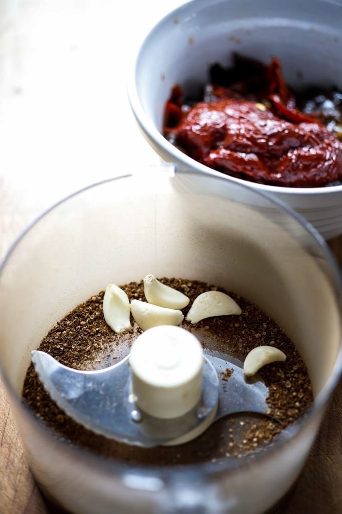 How to make Authentic Harissa Paste- a North African condiment that will add depth and smokey spice to meats, stews and roasted vegetable dishes. | www.feastingathome.com