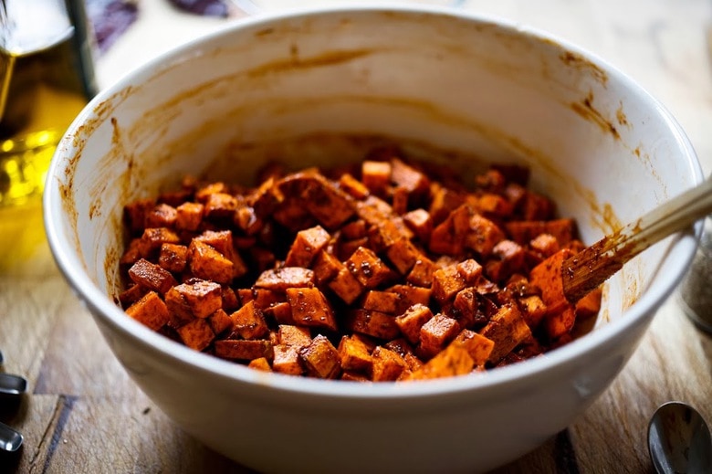 Sweet Potato Hash with Poached Eggs and Harissa Paste - a delicious, North-African inspired, one-skillet breakfast that is bursting with flavor! Gluten Free #sweetpotato #sweetpotatohash #harissa #harissapaste #harissasauce #eggs #morocan