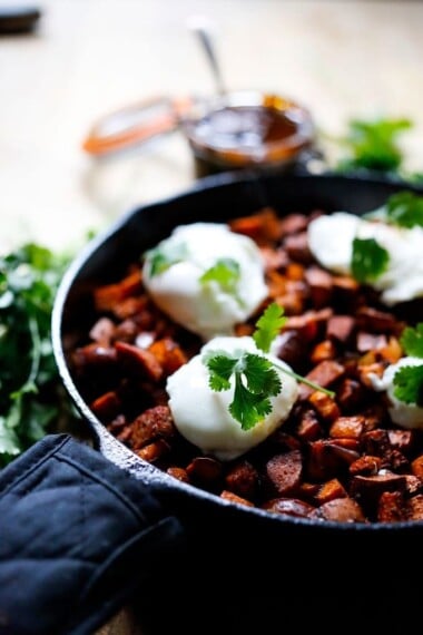 Sweet potato hash with Harissa, poached eggs and mergeuz sausage | www.feastingathome.com