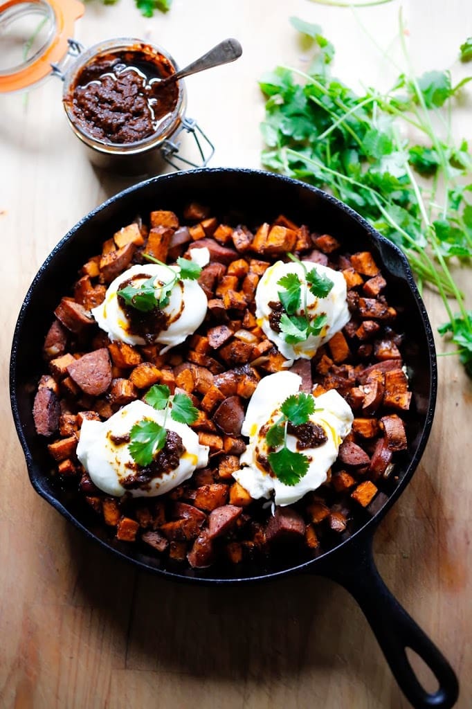 Sweet Potato Hash with Poached Eggs and Harissa Paste - a delicious, North-African inspired, one-skillet breakfast that is bursting with flavor!   Gluten Free #sweetpotato #sweetpotatohash #harissa #harissapaste #harissasauce #eggs #morocan 