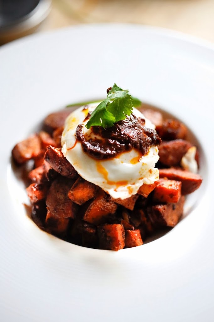 Sweet Potato Hash with Poached Eggs and Harissa Paste - a delicious, North-African inspired, one-skillet breakfast that is bursting with flavor!   Gluten Free #sweetpotato #sweetpotatohash #harissa #harissapaste #harissasauce #eggs #morocan 